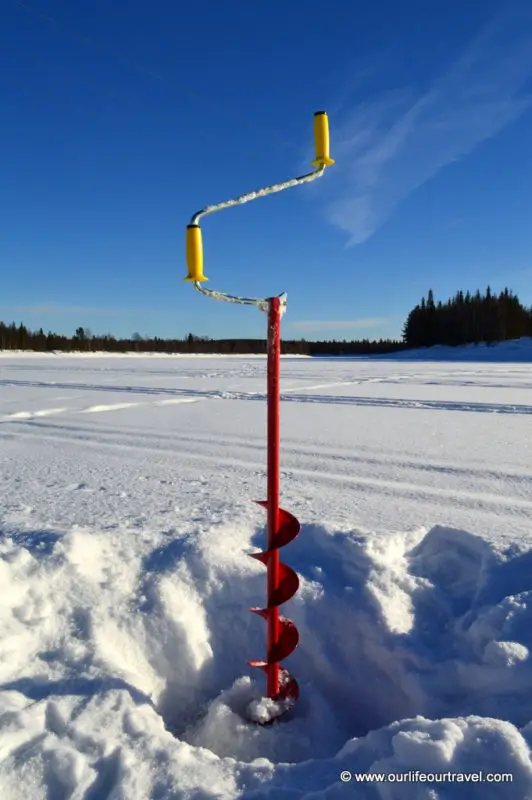 Drill: Ice-fishing in Lapland, Finland.