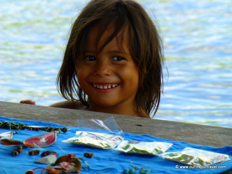 Little local girl selling handmade crafts. Visiting the rainforest near Manaus, Brazil.