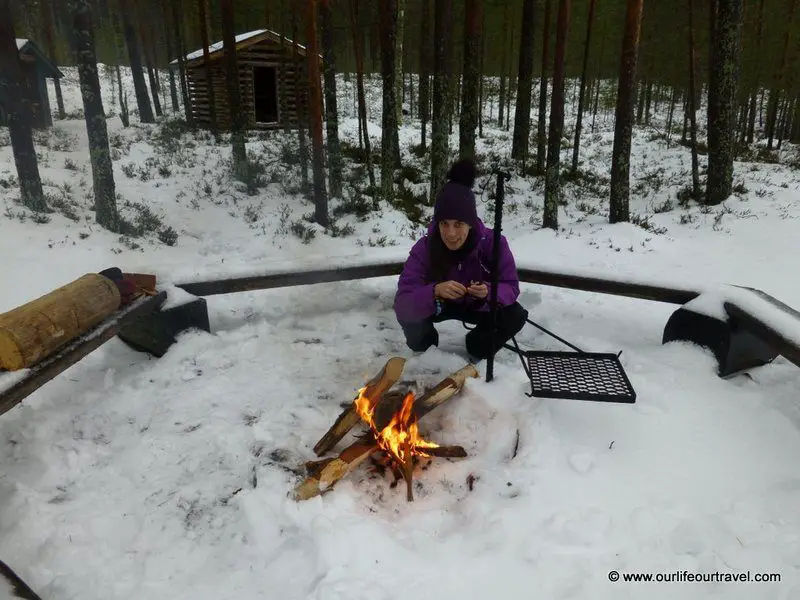 Making fire during the winter in front of a shelter in Finnish National Park