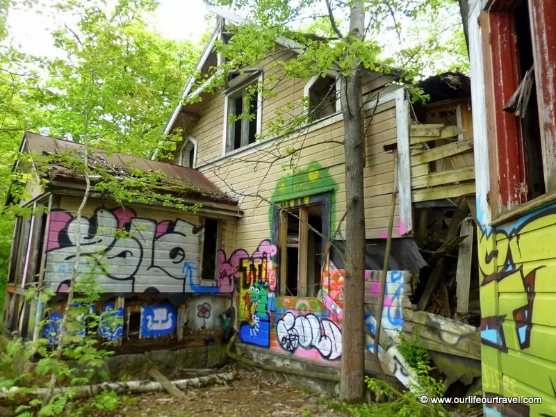 Abandoned villa covered with graffiti.