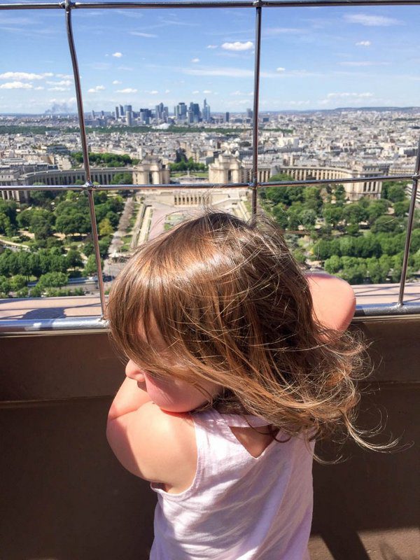 Little girl and the view from Eiffel Tower, Paris - Vacation in France with family.