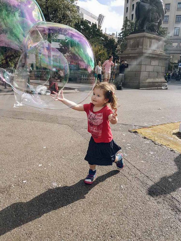 Chasing bubbles in Plaza Catalunya in Barcelona, Spain