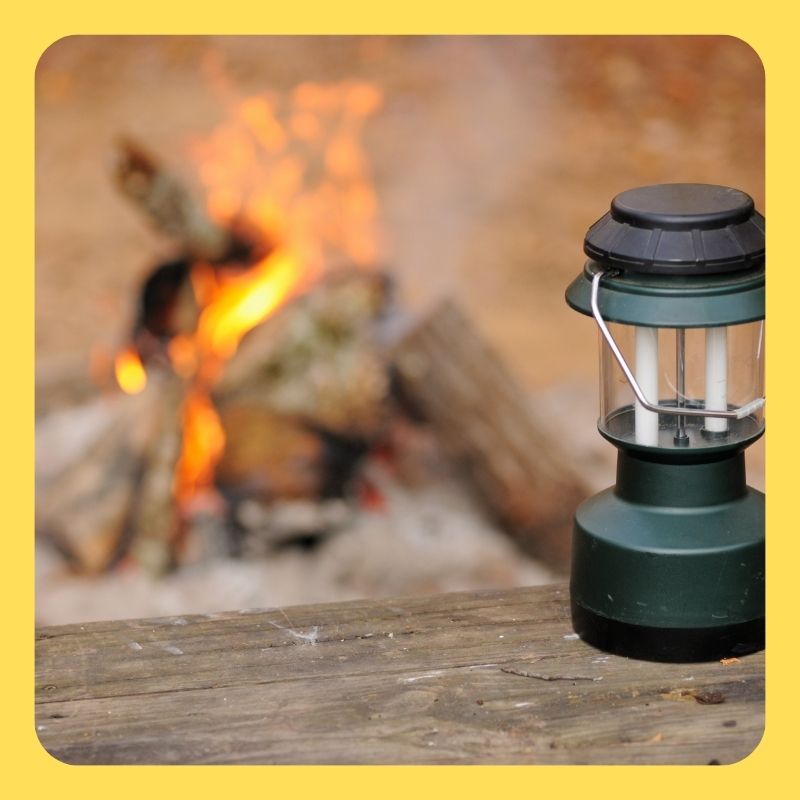 best camping gadgets: lanterns at the campfire