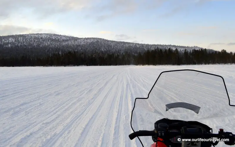 Riding a snowmobile around Levi, Finland